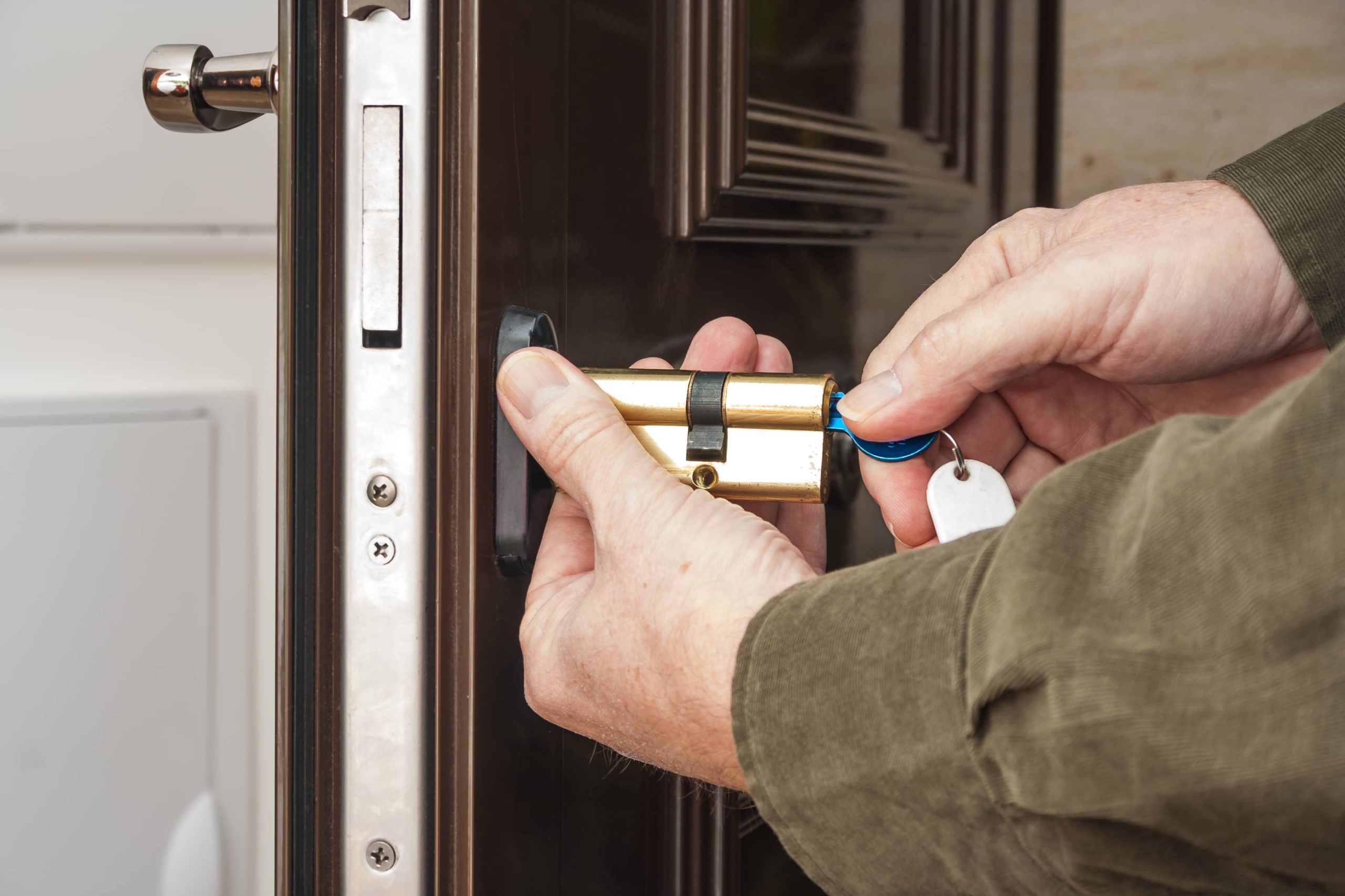 A locksmith replacing a brass door lock cylinder with a key, providing professional door lock replacement services in Mississauga Valleys for enhanced security. A locksmith replacing a brass door lock cylinder with a key, providing professional door lock replacement services in Mississauga Valleys for enhanced security.