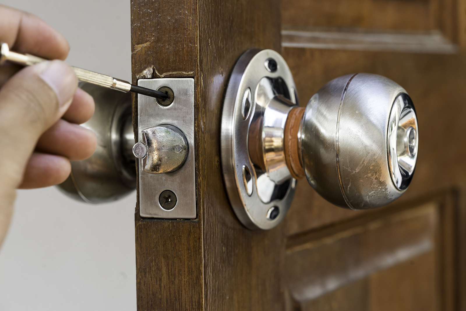Closeup Of Locksmith On Old Wood Door Repair Closeup Of Locksmith On Old Wood Door Repair